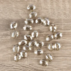 Perlen, oval, flach, 0,9cm x 1,2cm, facettiert, transparent, taupe, 25 Stück